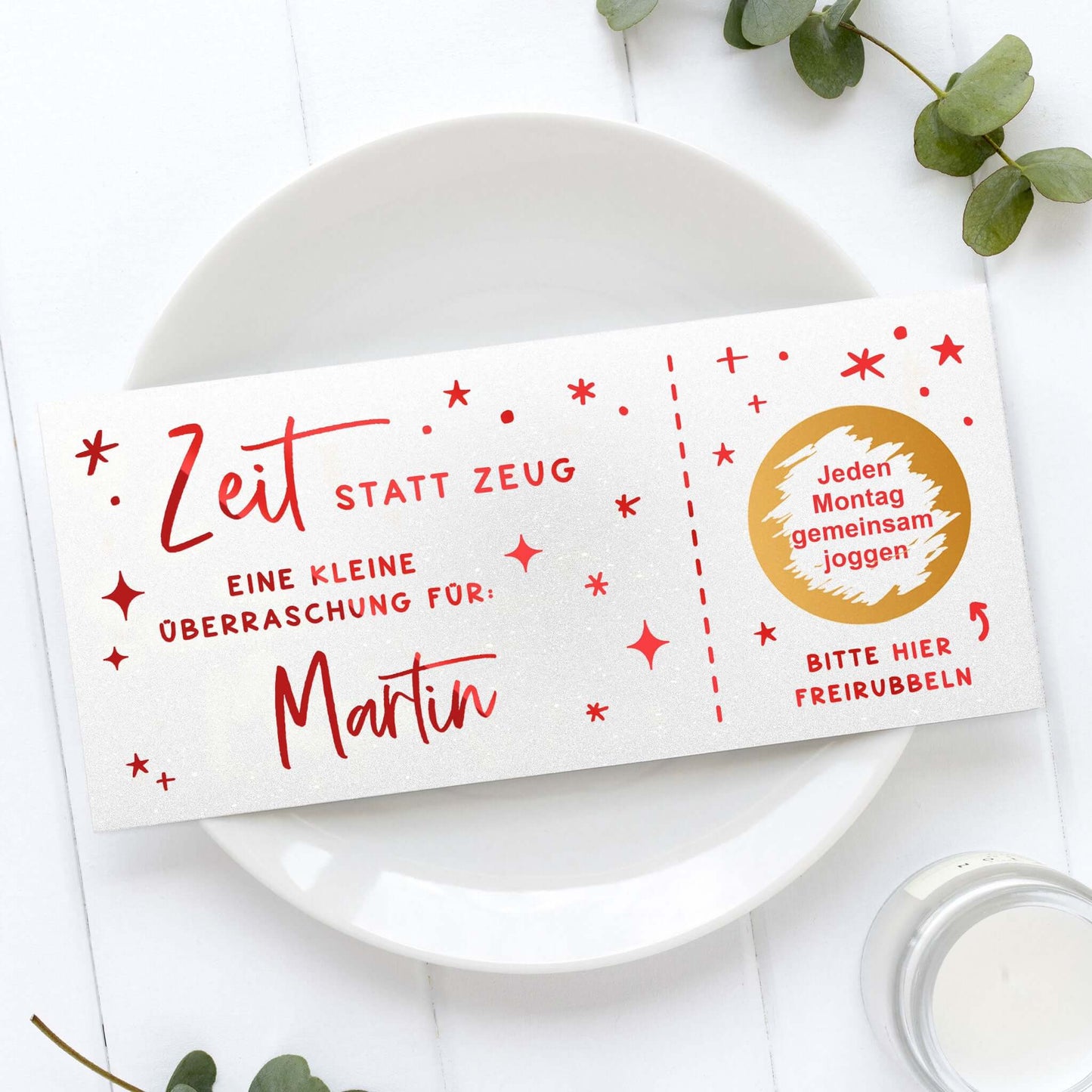 Rubbelgutschein personalisiert mit Sternen, Name Martin und dem Schriftzug „Zeit statt Zeug“ auf einem Teller.