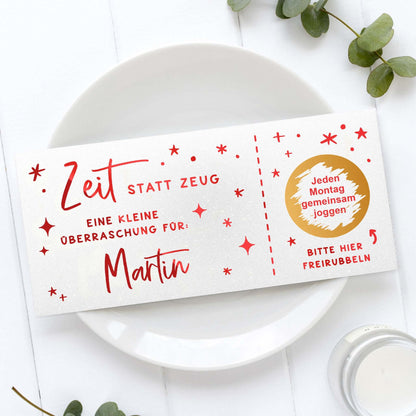 Rubbelgutschein personalisiert mit Sternen, Name Martin und dem Schriftzug „Zeit statt Zeug“ auf einem Teller.